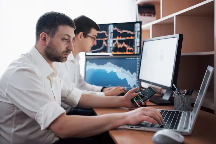 Team stockbrokers are having conversation dark office with display screens analyzing data graphs reports investment purposes creative teamwork traders 146671 15025